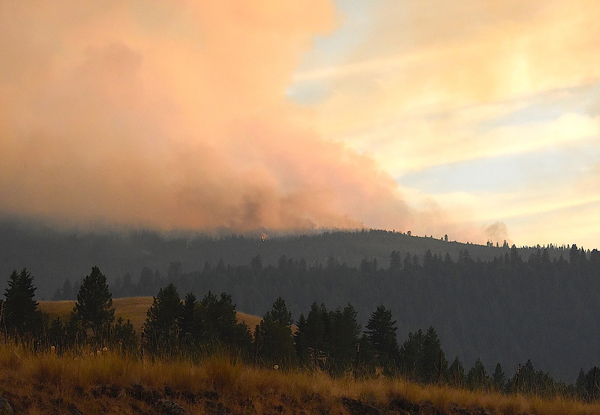 The Niarada fire last Tuesday evening shows flickers of flame. It's gotten considerably larger, and some residents have had to evacuate. (Berl Tiskus/Leader)