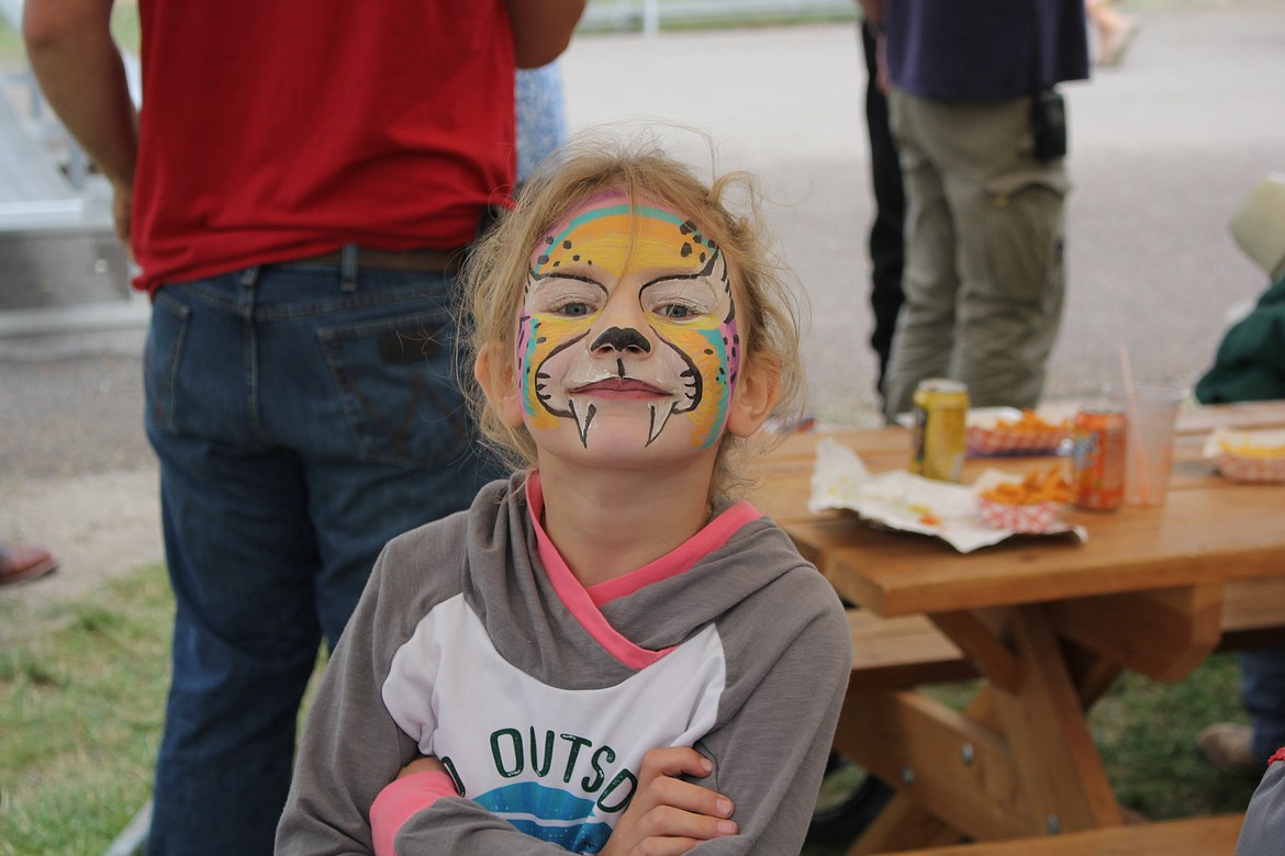 A fairgoer shows off her face painting artwork at the Mineral County Fair. (Monte Turner/Mineral Independent)