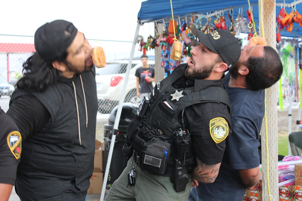 Contestants in the doughnut-eating contest found that eating a doughnut without hands required some maneuvering. The contest was part of National Night Out sponsored by the Mattawa Police Department.