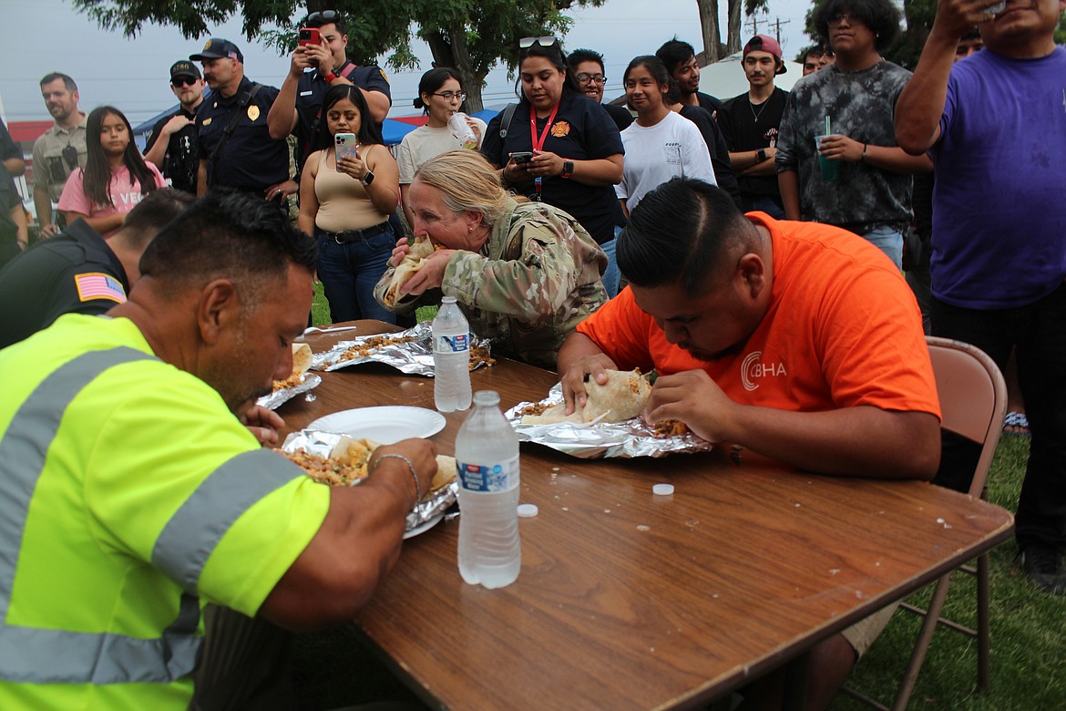 Contestants chow down on burritos during the burrito-eating contest.