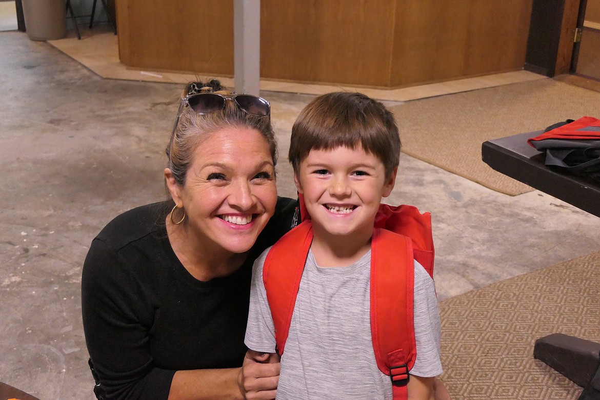 eather Thompson smiles along with her son Harrison after he picked out a "cool" new backpack for the coming school year. (Chuck Bandel/VP-MI)