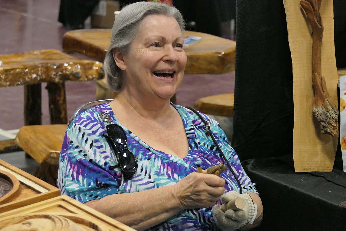 Wild Horse Wood Carvers member Janet Brandon works on a carving during this past weekend's Artists in Paradise exhibition and sale at the Paradise Center. (Chuck Bandel/VP-MI)