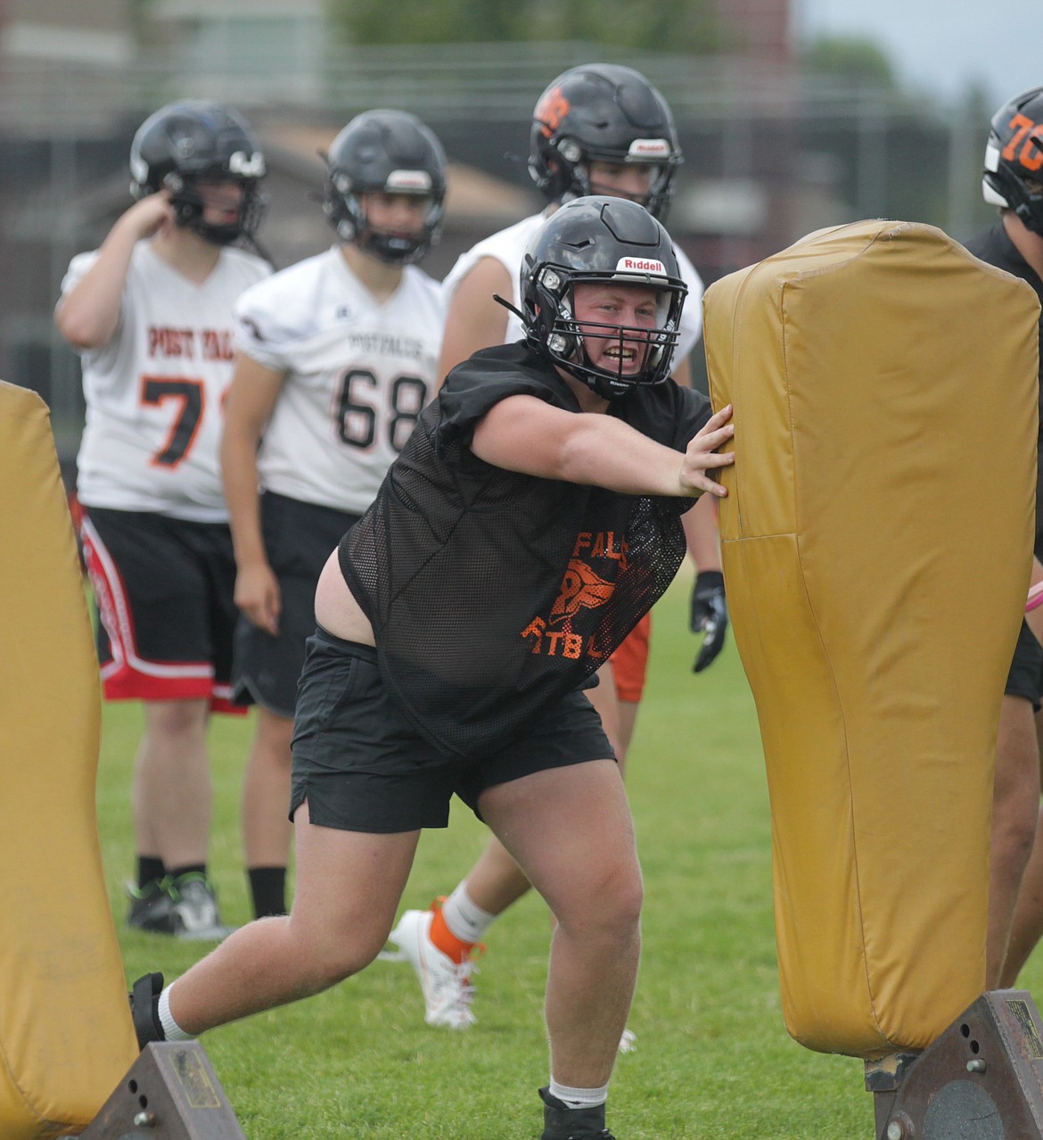 MARK NELKE/Press
Senior lineman Aidan Shamion hits the blocking sled during Post Falls High football practice Monday afternoon.