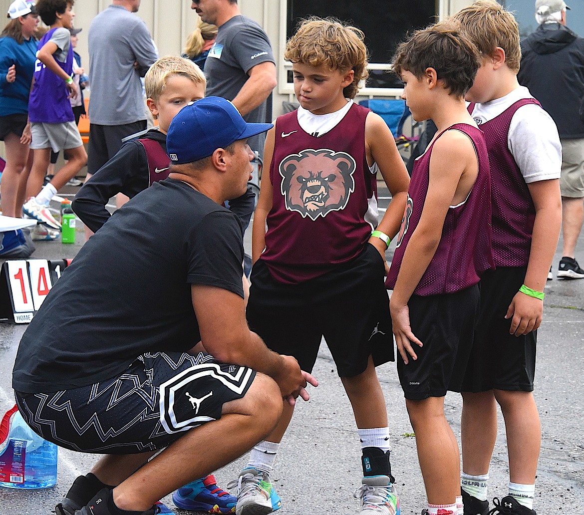 The 406 Destroyers from Missoula get a pep talk from their coach before the next game starts at the Pioneer Days 3-on-3. (Berl Tiskus/Leader)
