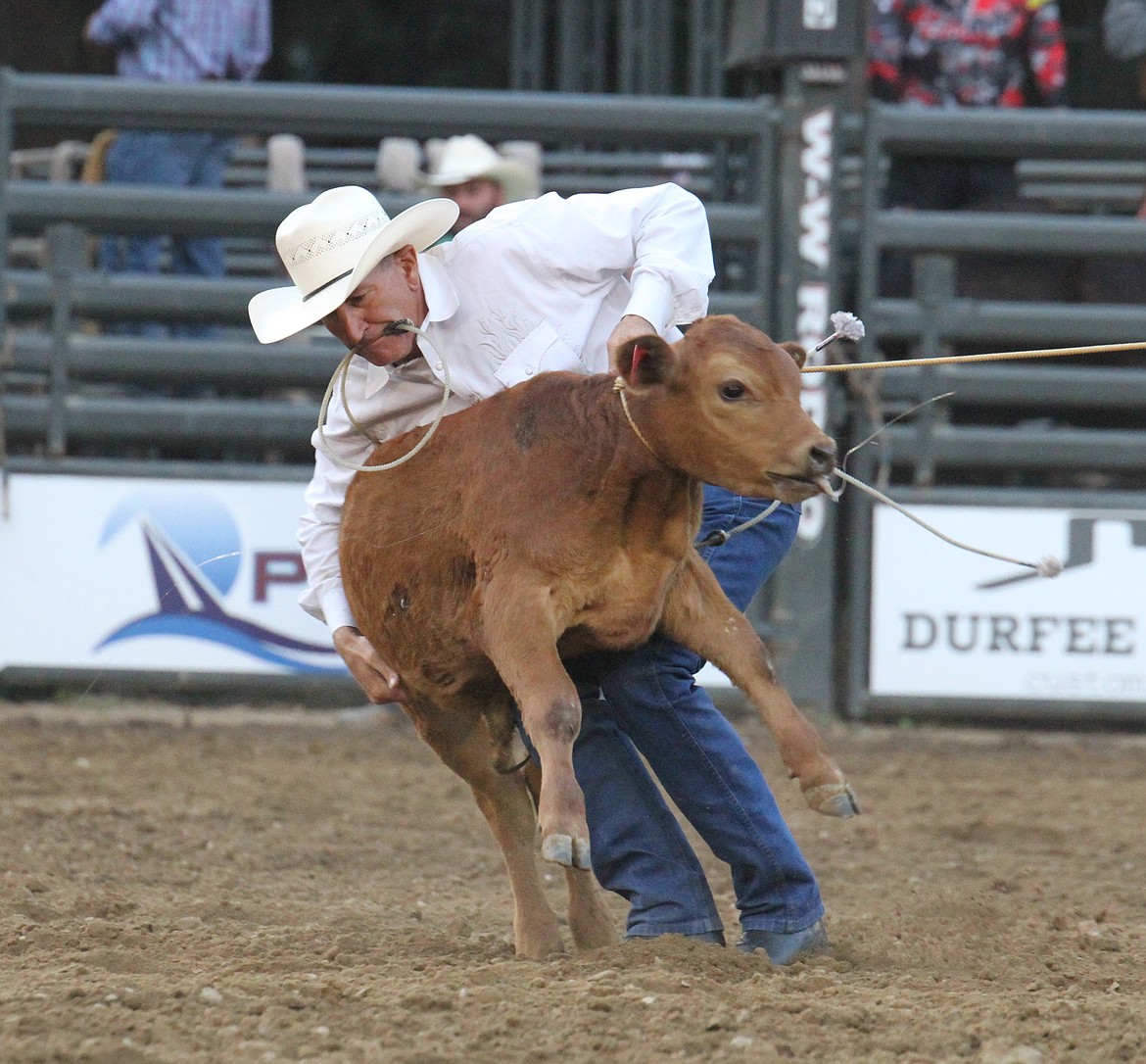A cowboy gets ready to take down a calf in the tie-down roping competition.