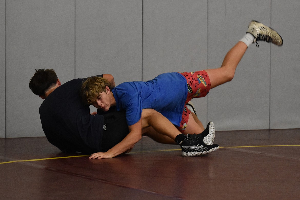 Moses Lake sophomore Ian Anderson, in blue, practices a takedown at Saturday’s camp. Anderson placed sixth at the World of Wrestling Reno Worlds tournament in Reno, Nevada.