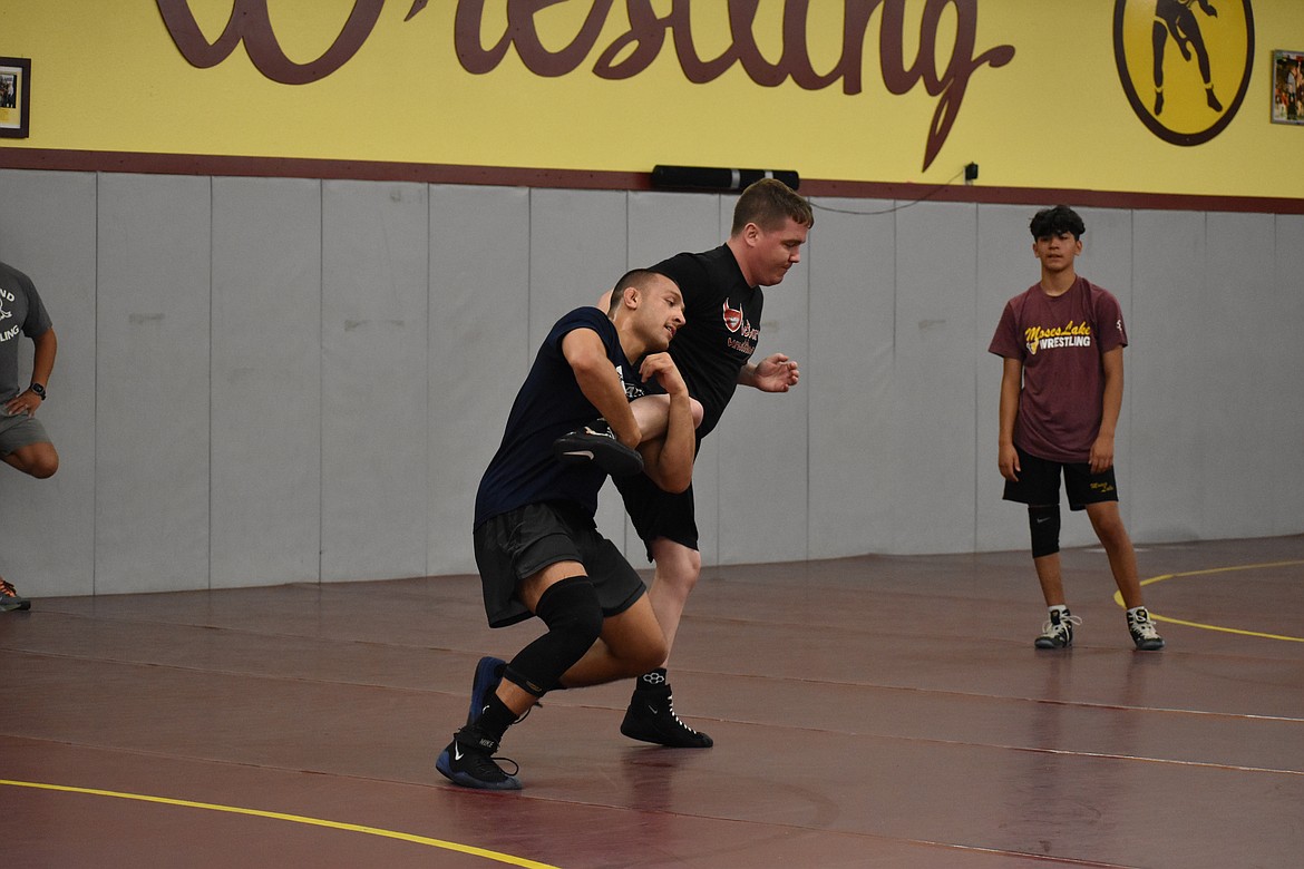 Collegiate wrestler Frank Almaguer, left, shows a move for campers at the Chasing Gold Camp on Saturday at Moses Lake High School.