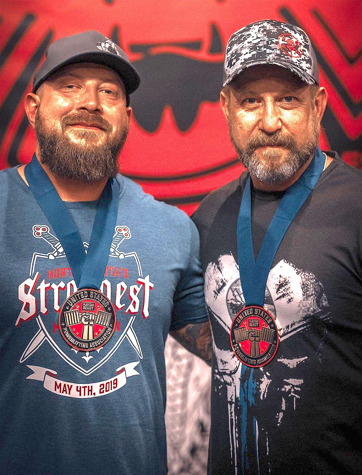 Scott Sciaretta and his son, Scott, are seen standing at their first meet competing together. Sciaretta's son is the one who helped encourage his passion for powerlifting.