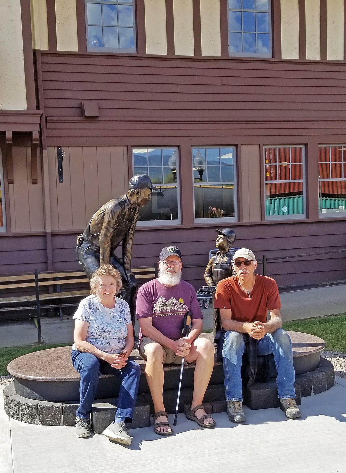Executive Director of the Stumptown Historical Society, Jill Evans with Karl Schenk, President of the Board of the Historical Society and Alex Hassan, owner of the statue, sit with the newly placed bronze that honors railroaders. (Photo provided)