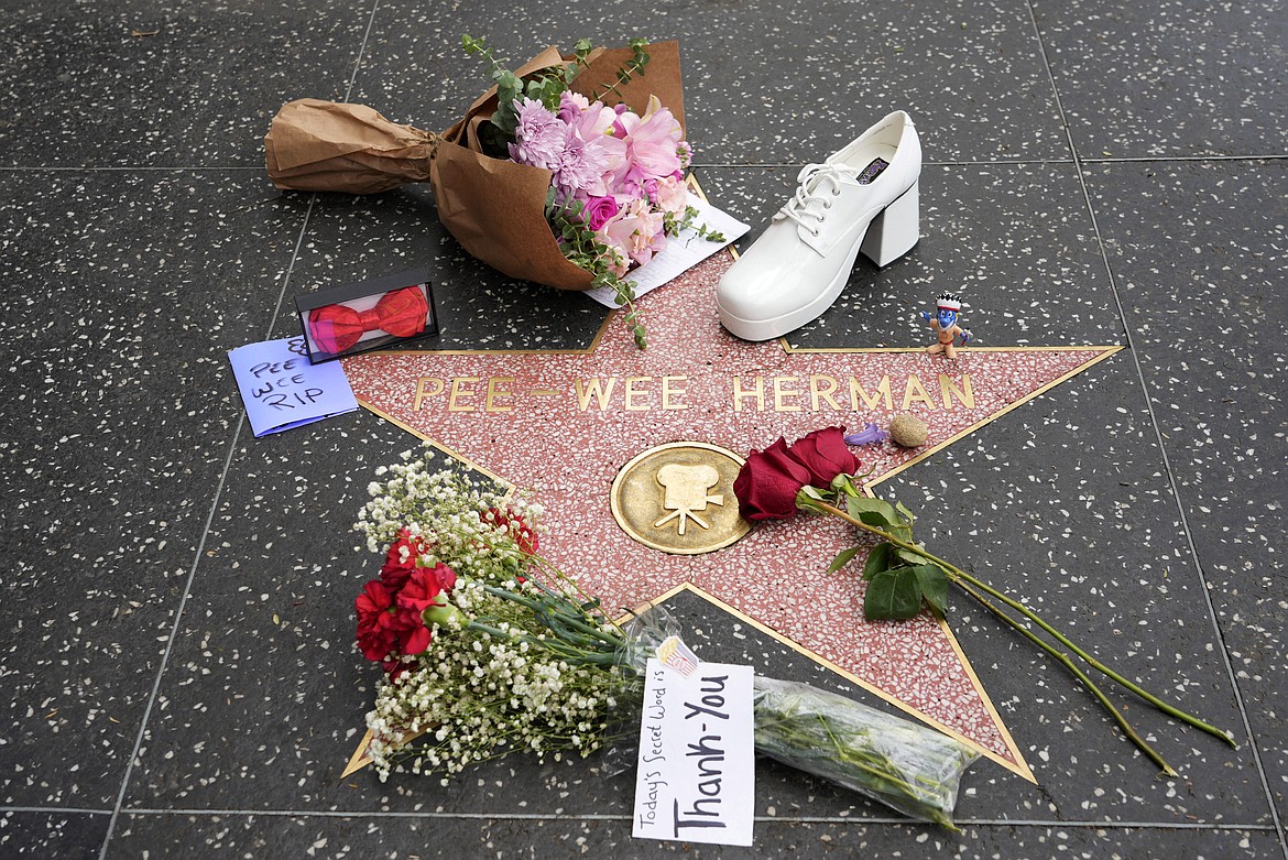 Flowers and mementos sit near the star of Pee-wee Herman on the Hollywood Walk of Fame, Monday, July 31, 2023, in Los Angeles.