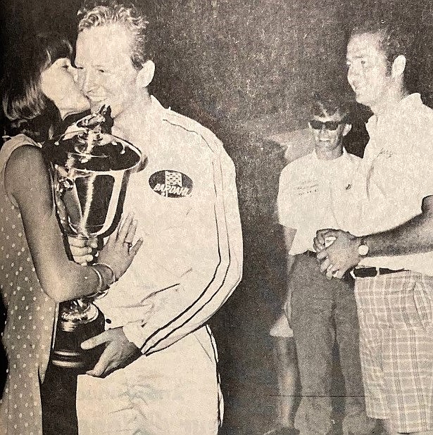 Billy Schumacher, 25, receives a kiss from Miss Diamond Cup Linda Dreschel after winning the 10th and final Diamond Cup while crew members watch.