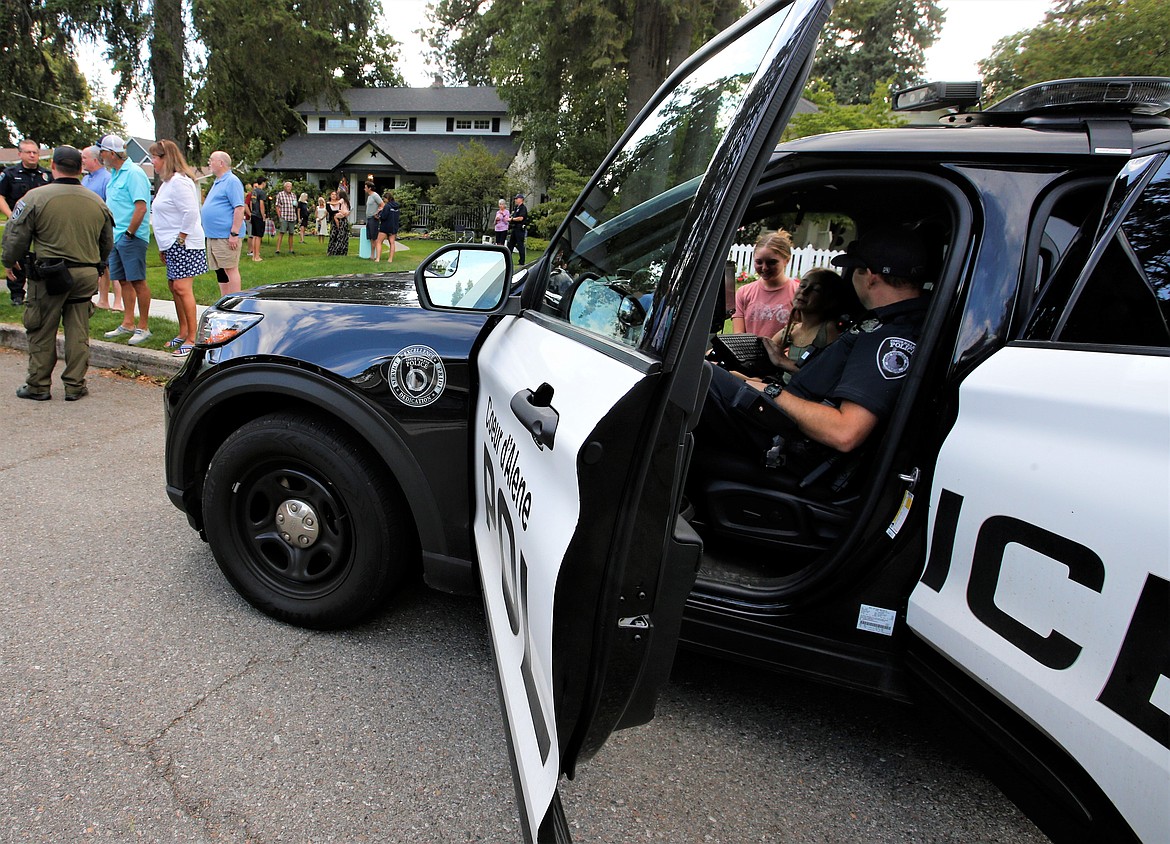 A Coeur d'Alene police officer talks with youth during National Night Out on Wednesday.