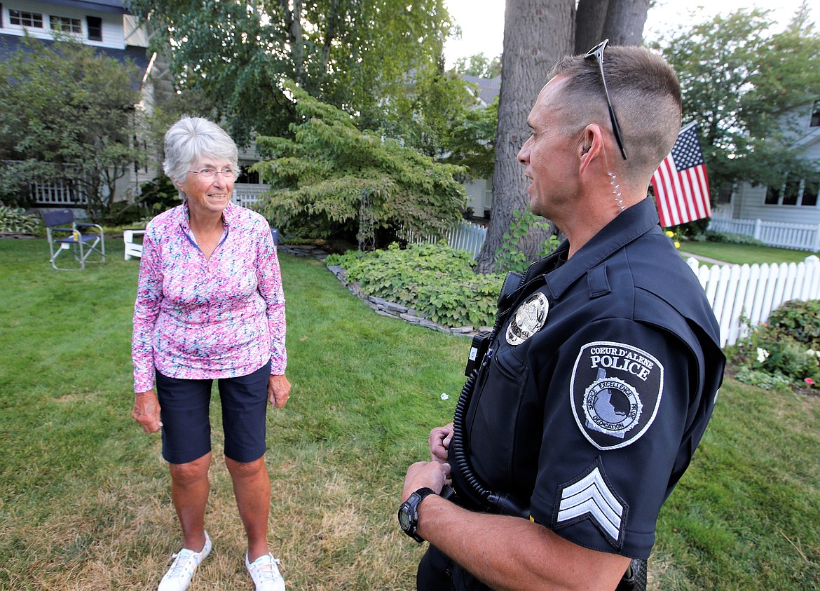 Coeur d'Alene Police Sgt. Jared Reneau chats with Ann Melbourne during a National Night Out gathering in the Fort Ground neighborhood on Wednesday.