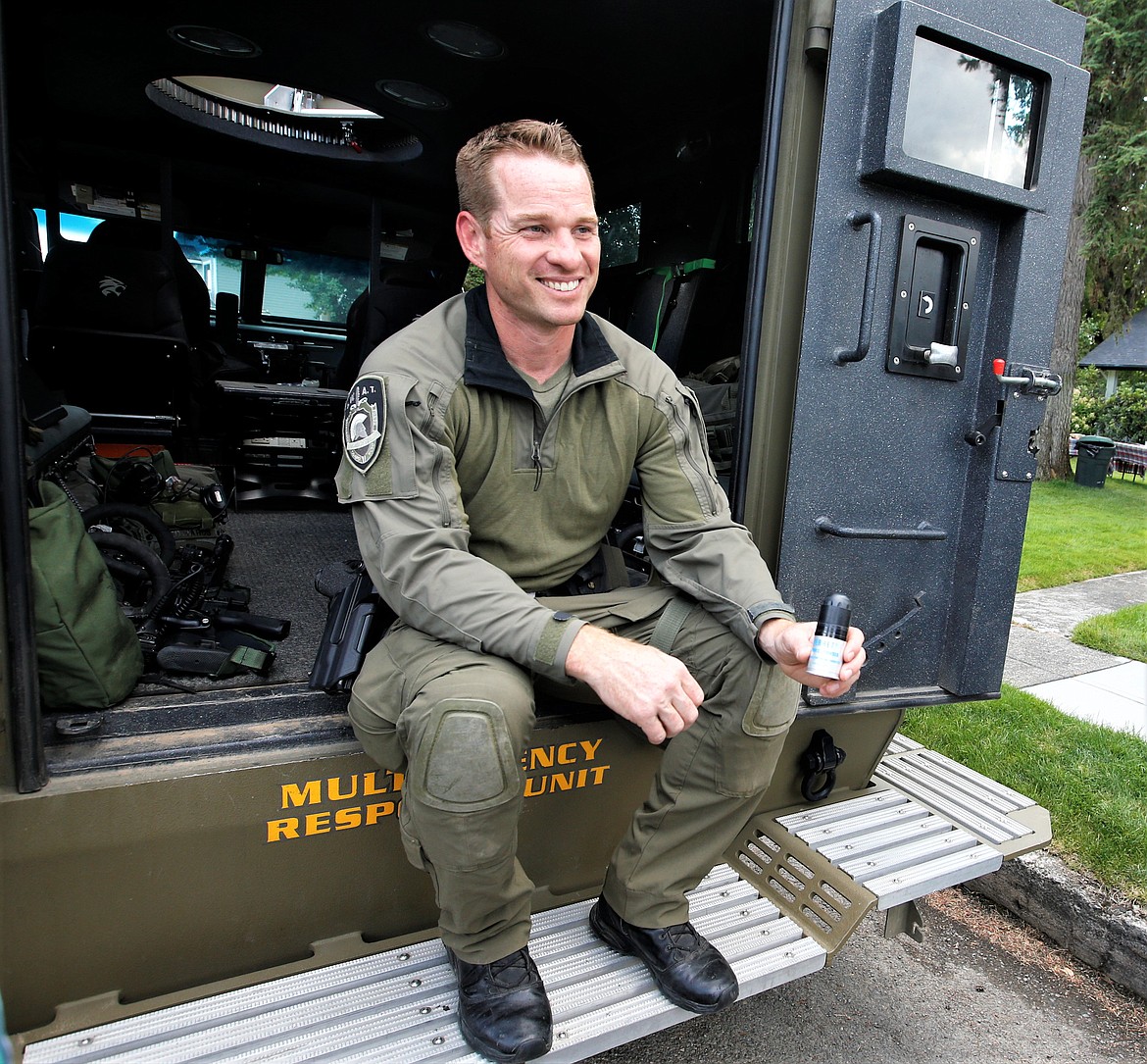 Coeur d'Alene Police Officer Caleb Hutchison talks about police resources during National Night Out on Wednesday.