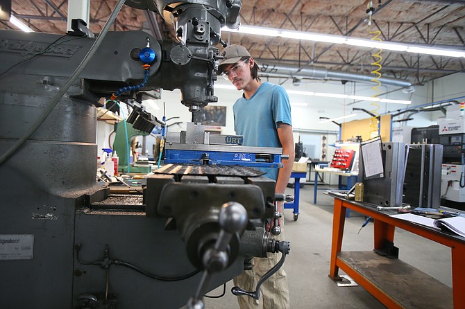 Tool and die maker apprentice Broden Donaldson crafts blocks to make products at different angles Aug. 2 at Tedder Industries in Post Falls.