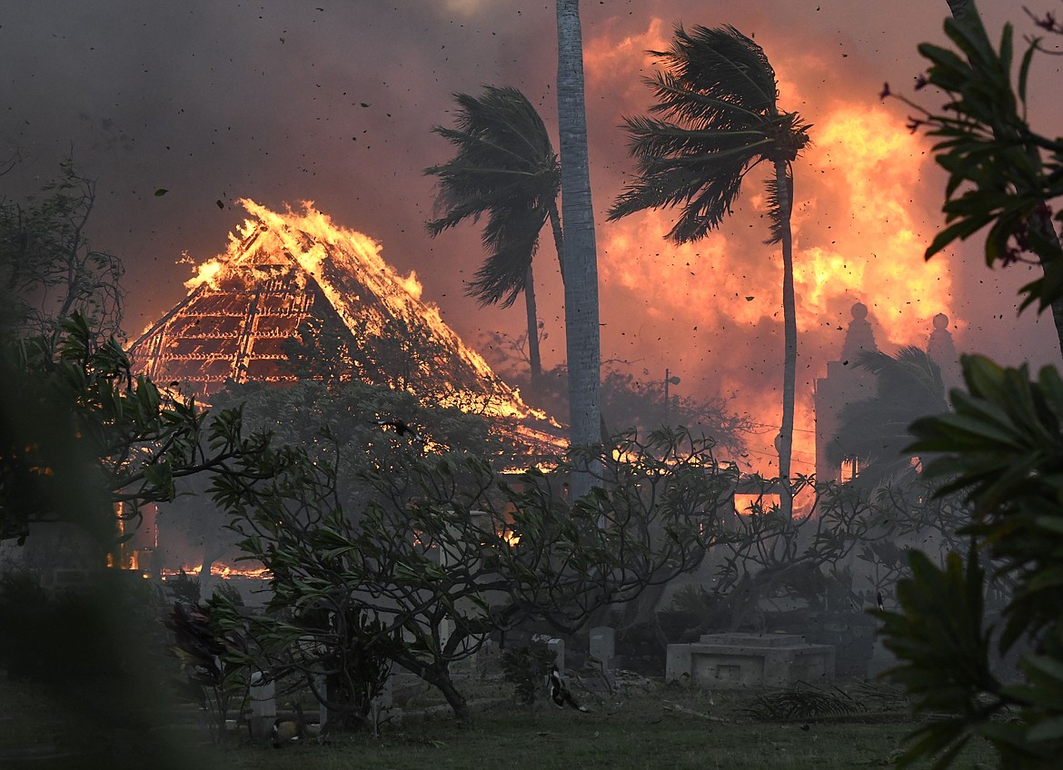 The hall of historic Waiola Church in Lahaina and nearby Lahaina Hongwanji Mission are engulfed in flames along Wainee Street on Tuesday, Aug. 8, 2023, in Lahaina, Hawaii. (Matthew Thayer/The Maui News via AP)