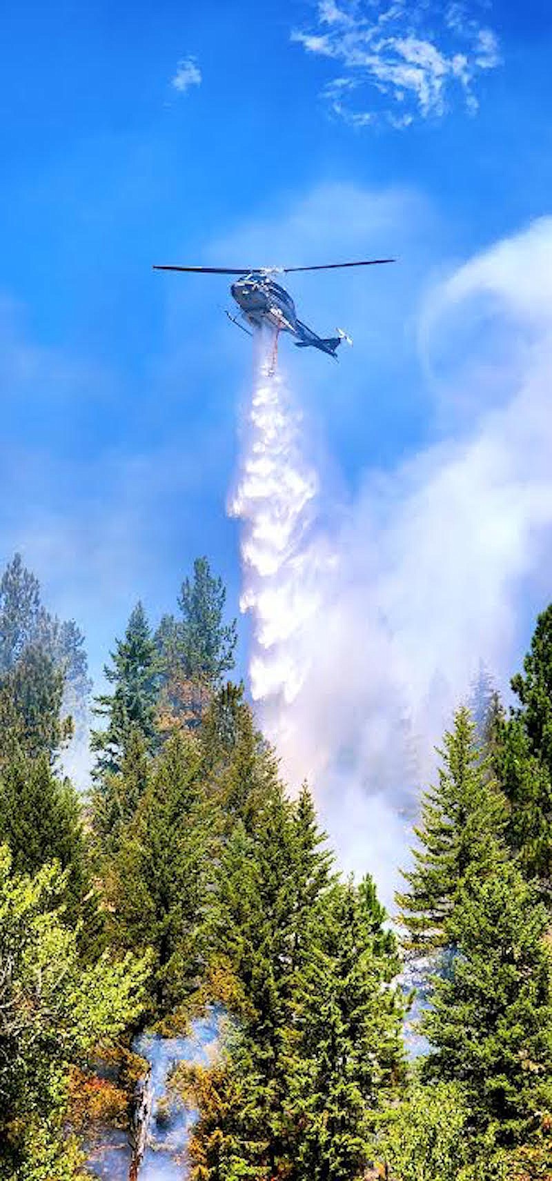 A helicopter drops water on the Gravel Pit Fire Friday, Aug. 4. (Photo courtesy Lincoln County Sheriff's Office Deputy Andrew Smith)