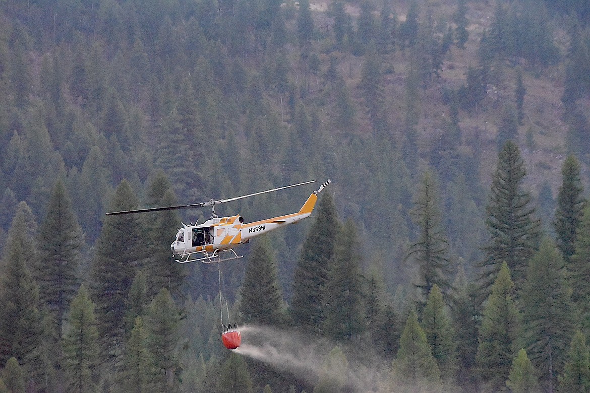 A helicopter heads toward the Olson Creek Fire Tuesday evening. (Scott Shindledecker/The Western News)