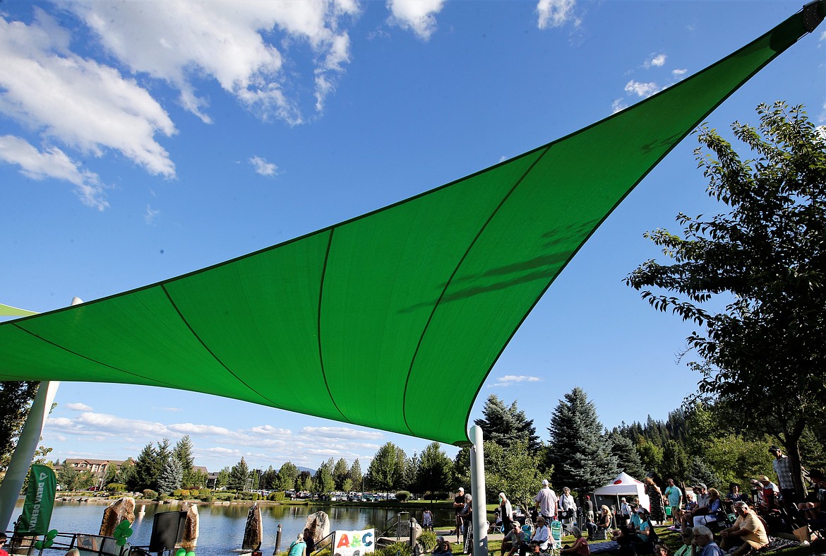 A green sail provides shade at the Riverstone Summer Concert Series on Thursday.