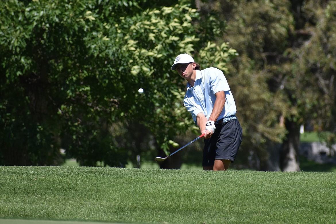 A golfer takes a swing onto the ninth green at the Washington Junior Golf Association State Championship on Thursday.