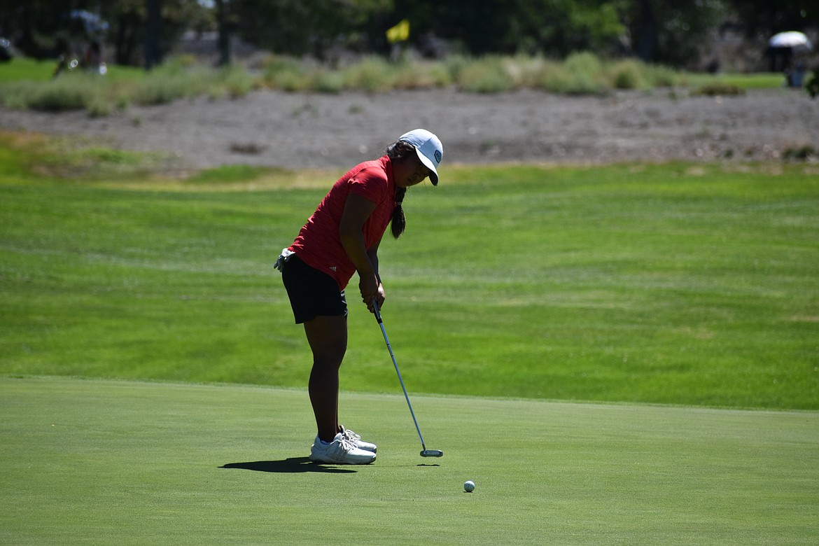 A golfer putts on the 18th green at the Moses Lake Golf Club in the Washington Junior Golf Association State Championship.