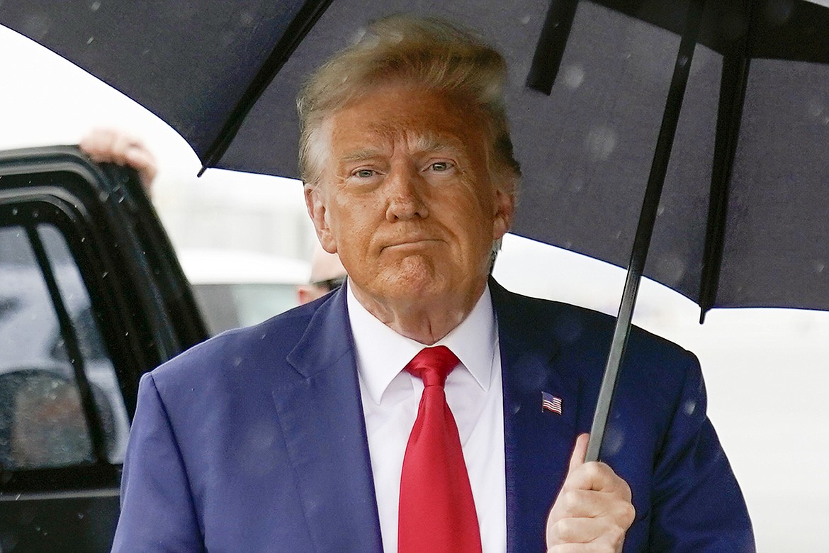 Former President Donald Trump walks to speak with reporters before boarding his plane at Ronald Reagan Washington National Airport, Aug. 3, 2023, in Arlington, Va. The federal judge overseeing the 2020 election conspiracy case against Donald Trump will hear arguments over a request by prosecutors for a protective order seeking to bar the former president from publicly disclosing evidence shared by the government. (AP Photo/Alex Brandon, File)