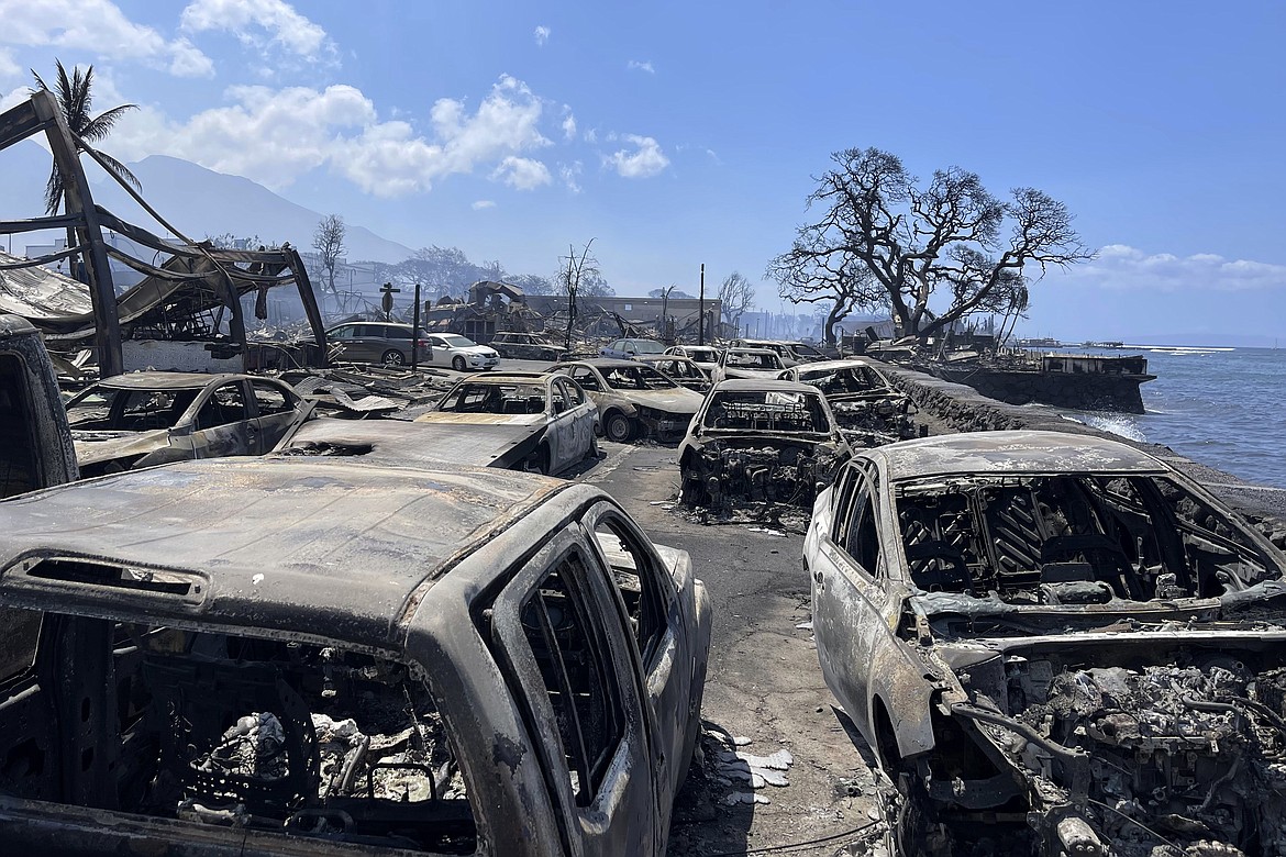 In this photo provided by Tiffany Kidder Winn, burned-out cars sit after a wildfire raged through Lahaina, Hawaii, on Wednesday, Aug. 9, 2023. The scene at one of Maui's tourist hubs on Thursday looked like a wasteland, with homes and entire blocks reduced to ashes as firefighters as firefighters battled the deadliest blaze in the U.S. in recent years. (Tiffany Kidder Winn via AP)