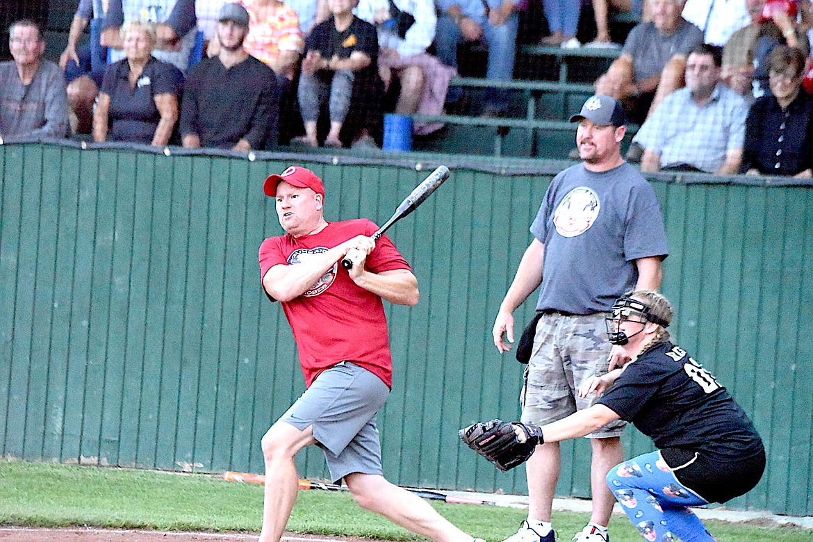 Hoses team member Scott Beagle collects a hit at the 2023 Guns and Hoses game at Lee Gehring Field in Libby on Thursday, Aug. 10. (Scott Shindledecker/The Western News)