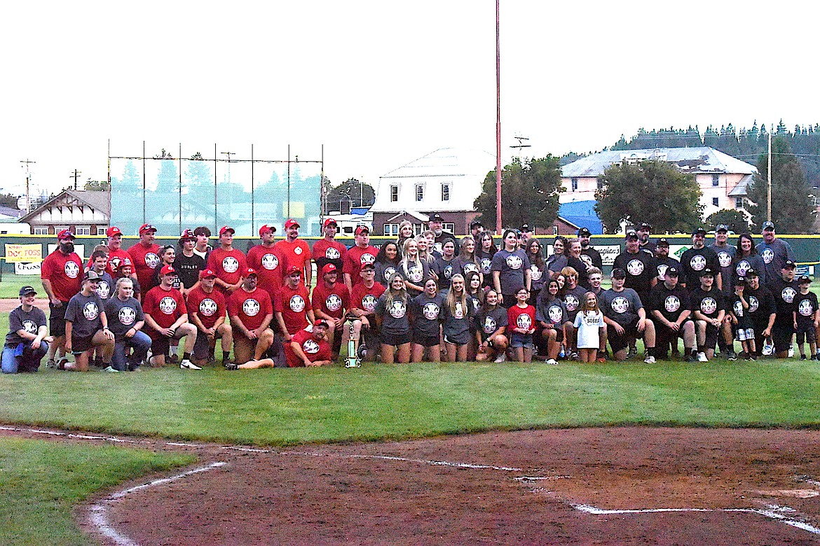 The Guns and Hoses teams gathered for a photo with the kids after the 2023 game at Lee Gehring Field in Libby on Thursday, Aug. 10. (Scott Shindledecker/The Western News)