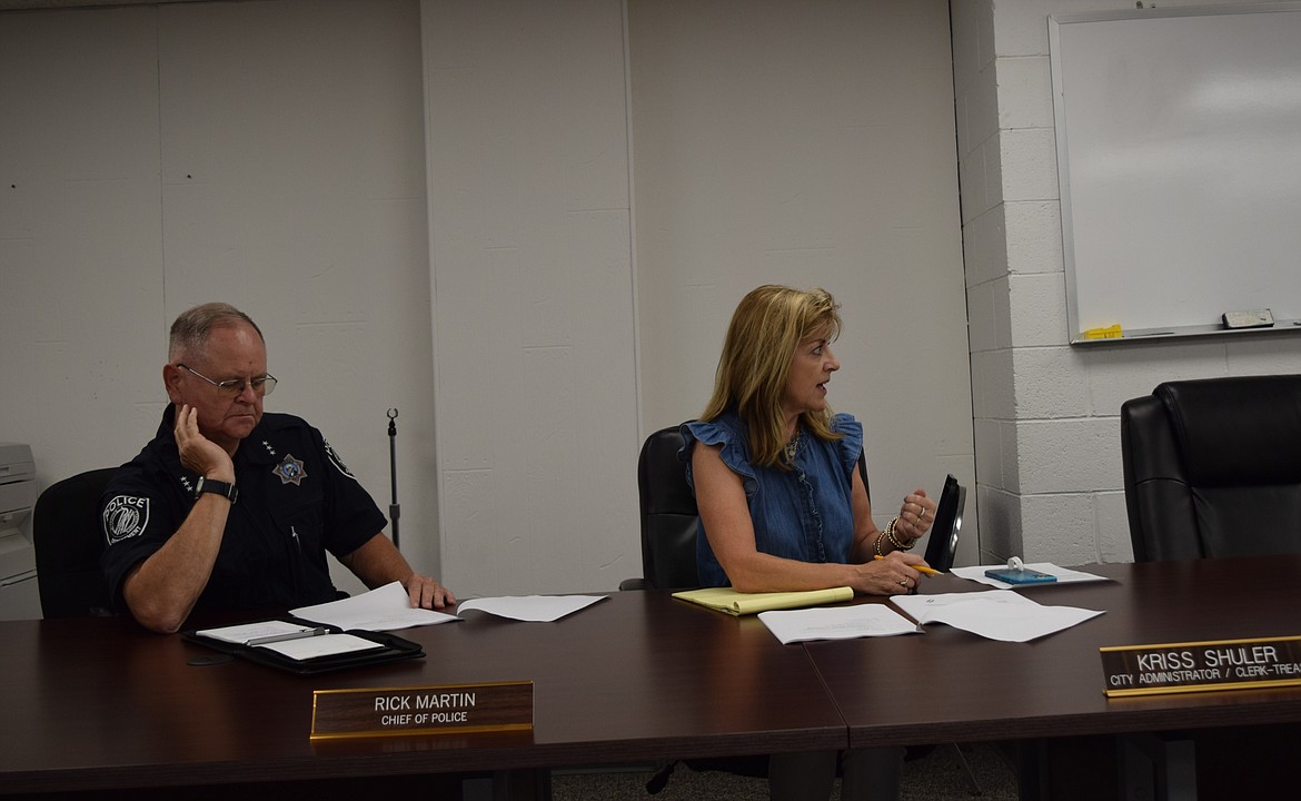 Warden Chief of Police Rick Martin and City Administrator Kriss Shuler sit before the Warden City Council during Tuesday’s regular meeting while Shuler explains the proposed grant applications for city roads.