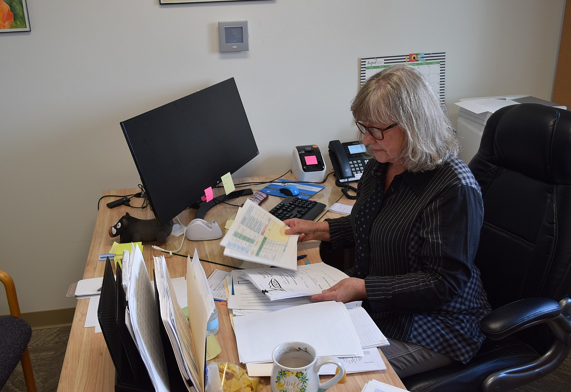 Community Services of Moses Lake Financial Manager Nan Gardener looks over papers at her desk in CSML’s offices. Gardener is working on implementing grant funding from the state to work with local socially disadvantaged farmers.