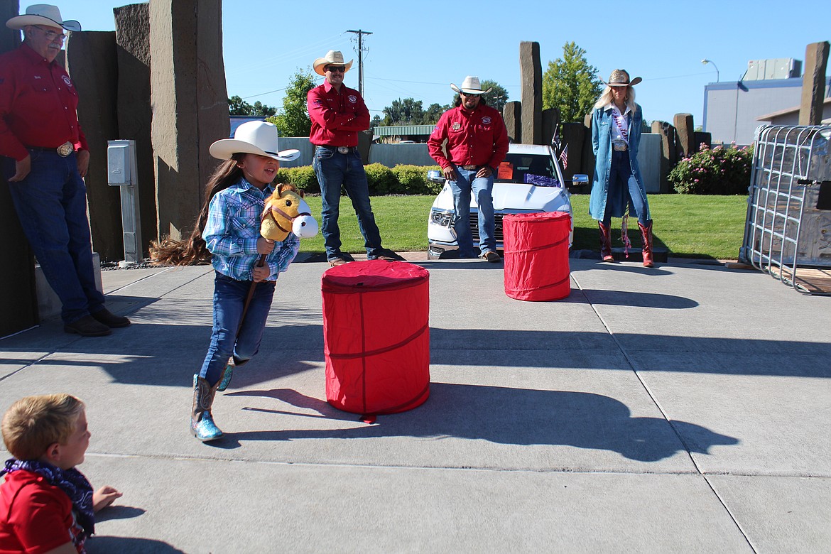 A barrel racer runs the course at Friday’s Cowboy Breakfast, the traditional kickoff for the Grant County Fair and Moses Lake Roundup.