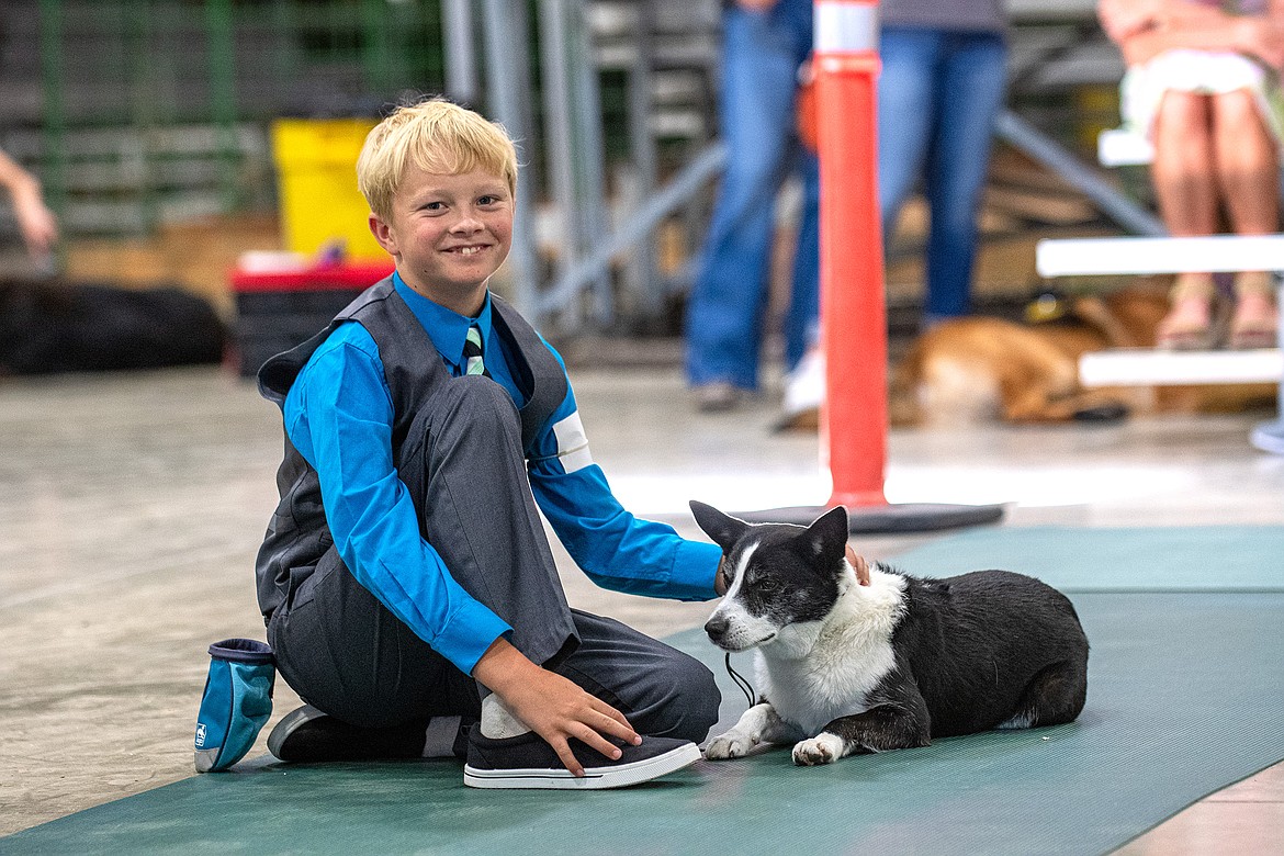 Junior grand champion showman Colton Oedekoven poses with his dog Meadow during the 4-H Dog Show at Flathead County Fairgrounds in Kalispell on Friday, Aug. 11. (Avery Howe/Hungry Horse News)