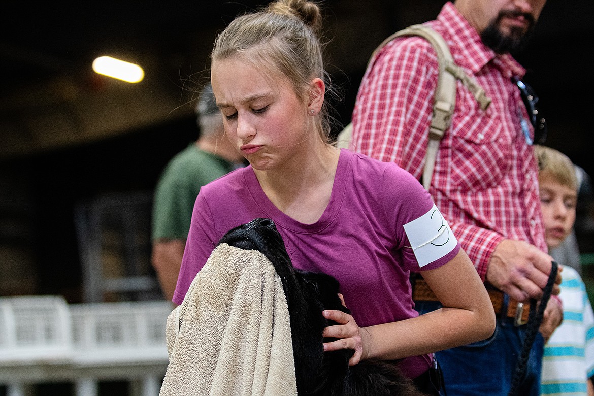 Elliot Schwartzenberger wipes her dog Mack's face before the 4-H Dog Show at Flathead County Fairgrounds in Kalispell on Friday, Aug. 11. (Avery Howe/Hungry Horse News)