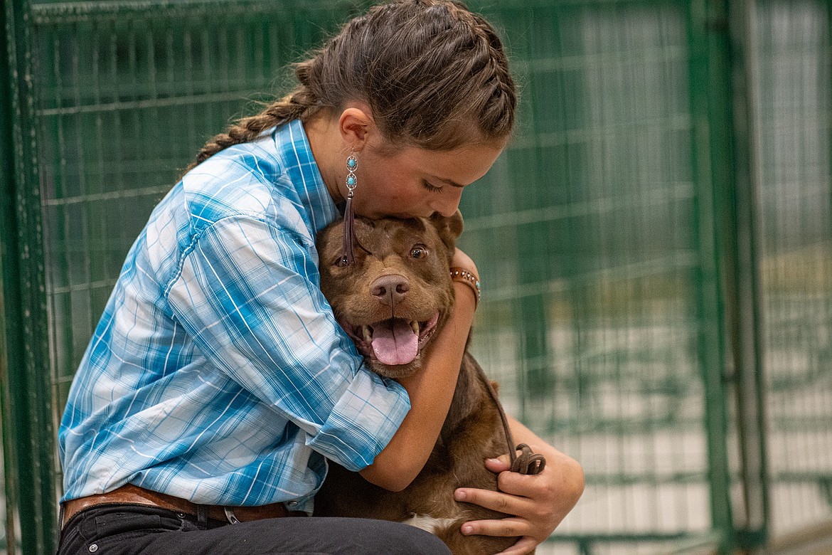 Natalie Smith hugs her dog Shelli before they hit the ring at the 4-H Dog Show at Flathead County Fairgrounds in Kalispell on Friday, Aug. 11. (Avery Howe/Hungry Horse News)