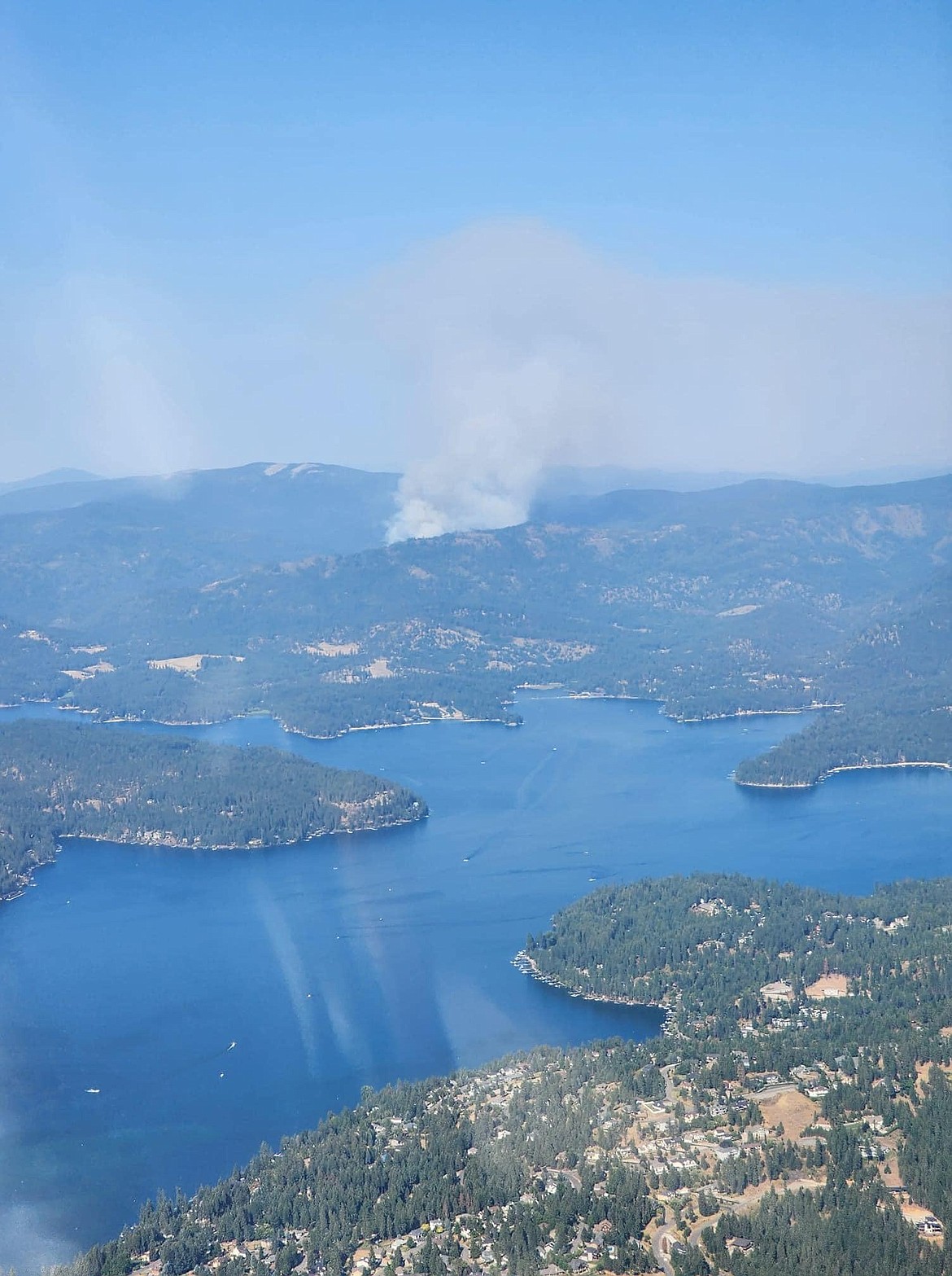 A view of a smoke plume from the Ridge Creek Fire, looking over Hayden Lake. A community meeting on the fire is being held Sunday.