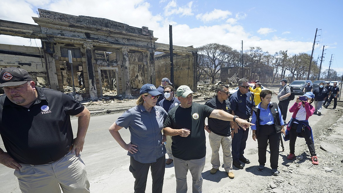 Governor of Hawaii Josh Green, center, points to damage as he speaks with FEMA Administrator Deanne Criswell during a tour of wildfire damage on Saturday, Aug. 12, 2023, in Lahaina, Hawaii. (AP Photo/Rick Bowmer)