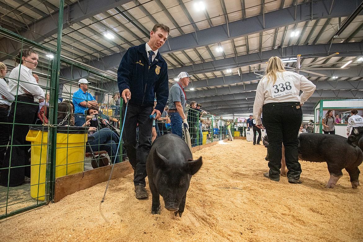 Aiden DeLong redirects his pig during the showmanship competition at Flathead County Fairgrounds in Kalispell on Monday, Aug. 14. (Avery Howe/Hungry Horse News)