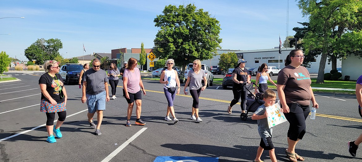 Moses Lake Police Chief Kevin Fuhr, in black shirt and jean shorts, walks and visits with other participants in the local version of the Obliteride fundraiser for Fred Hutch. Fuhr also credits his wife, next to him in pink shirt, and his daughter for helping him keep a positive attitude after being diagnosed with a rare form of gallbladder cancer late last year.