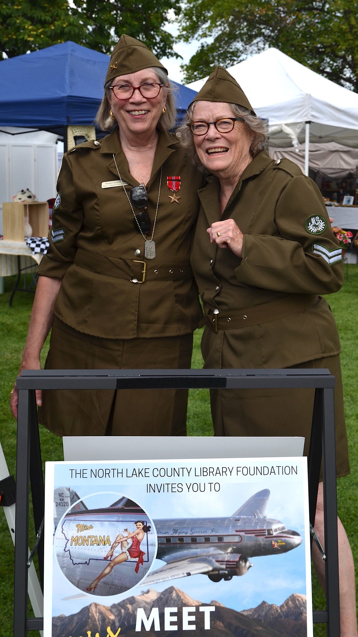 North Lake County Library Foundation members Nancy Armistead and Cindy Willis sold tickets to this weekend's visit by the historic Miss Montana C-47 airplane during Saturday's Courthouse Art Festival. (Kristi Niemeyer/Leader)