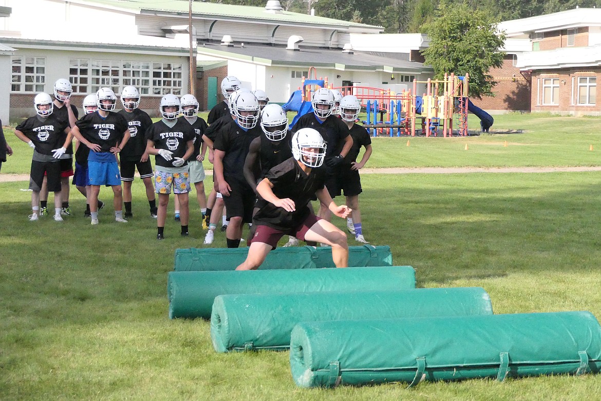 St. Regis senior John Pruitt (red trunks) works on an agility drill set up during pre-season practices last week in St. Regis in preparation for the season opener this Friday in Clark Fork, Idaho. (Chuck Bandel/MI-VP)