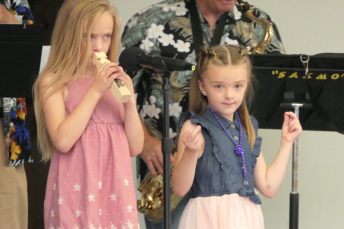 Kalispell area sisters Kodi (right) and Madison Holmes perform on stage during entertainment under the parachute roof at this year's Huckleberry Festival in Trout Creek.  (Chuck Bandel/VP-MI)