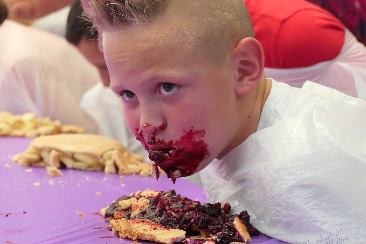 Snohomish, Washington resident Cohen Bringedahl pauses during the pie-eating contest during Saturday's Huckleberry Festival in Trout Creek.   (Chuck Bandel/VP-MI)