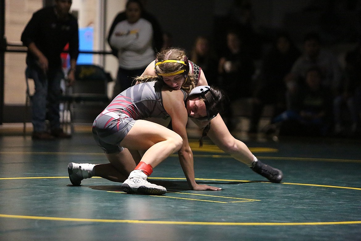 Moses Lake sophomore Reese Prescott, top, wrestles in the finals at a tournament hosted at Quincy High School in the 2023 season.