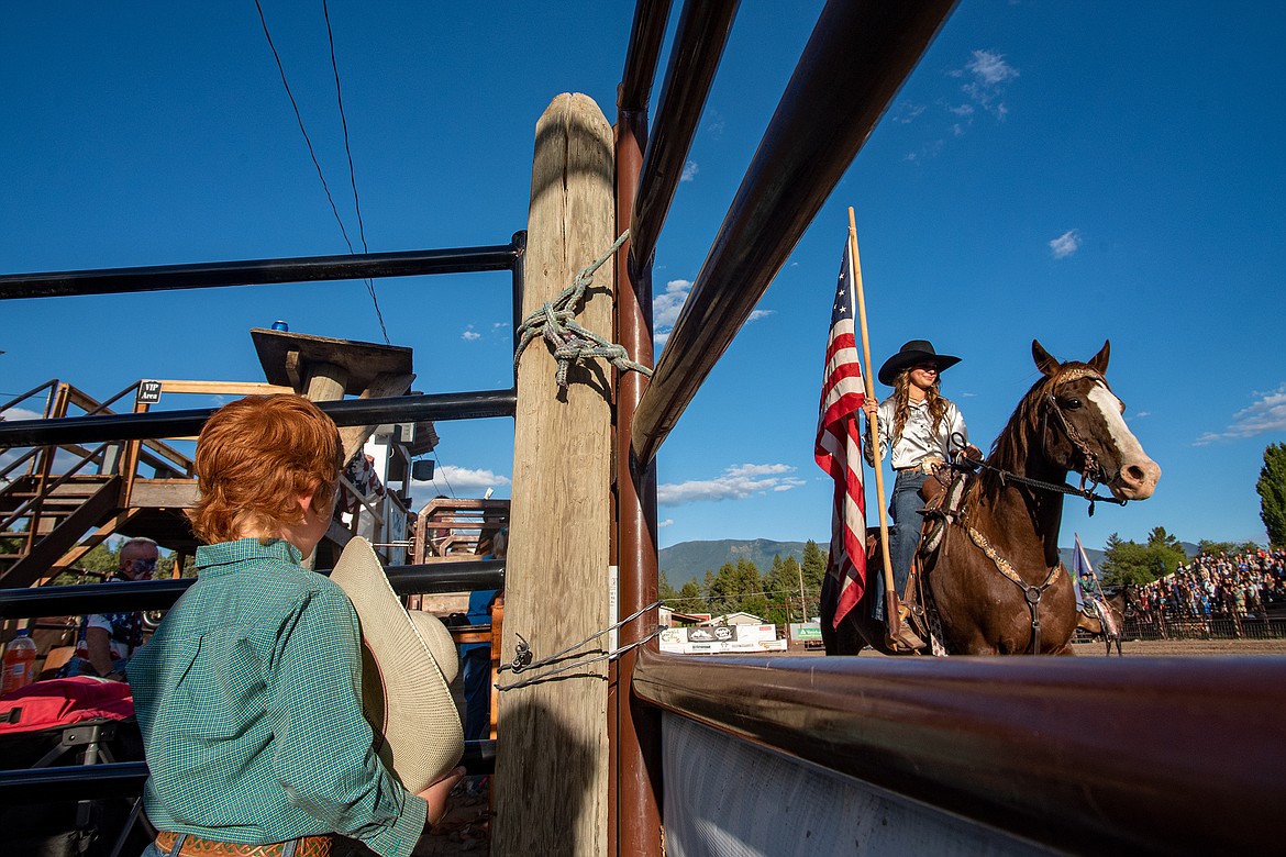 Ridge Gage takes off his hat to watch the colors be presented at the Blue Moon Bull Bash.