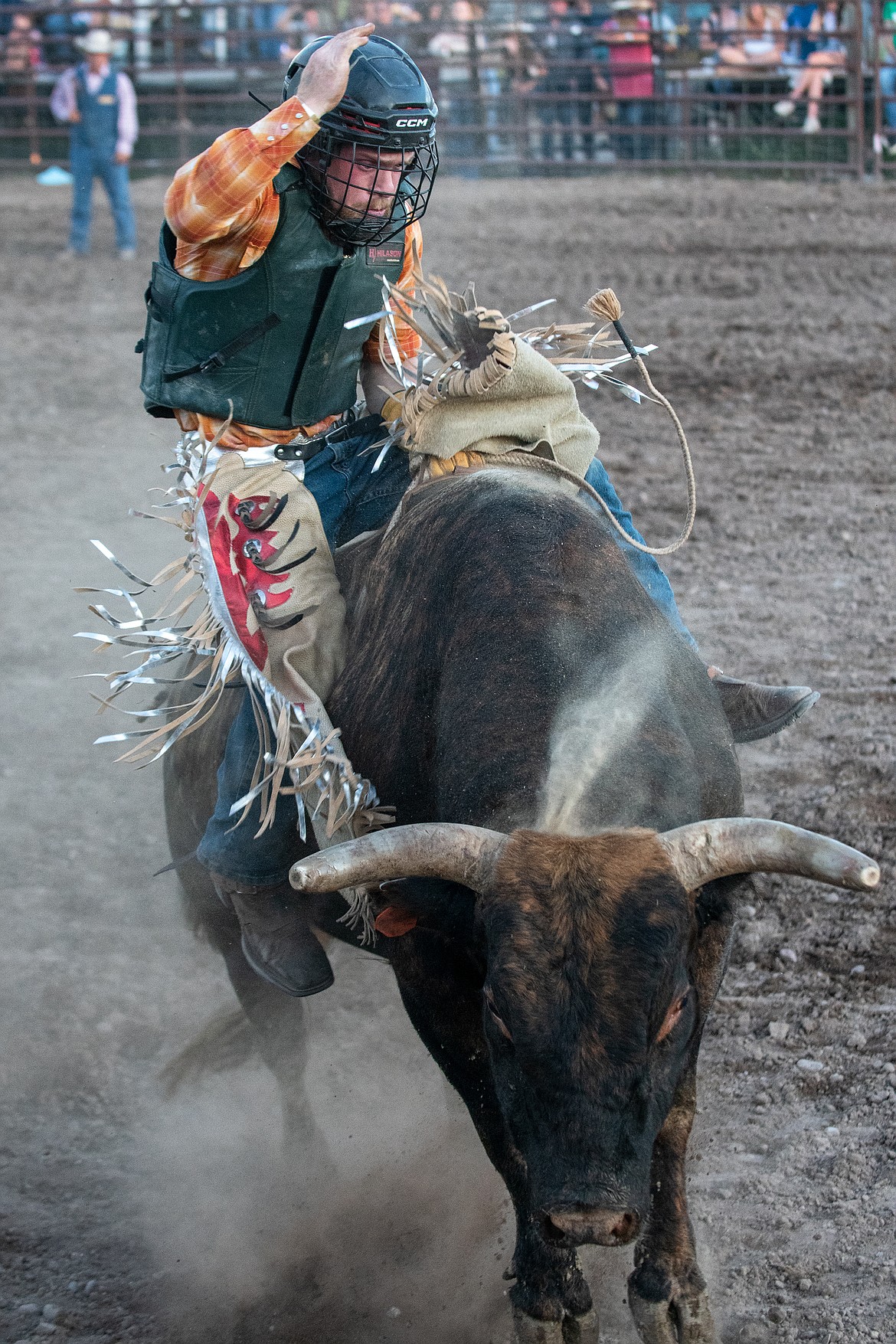 A bullrider hangs on tight during the Bull Bash on Friday.