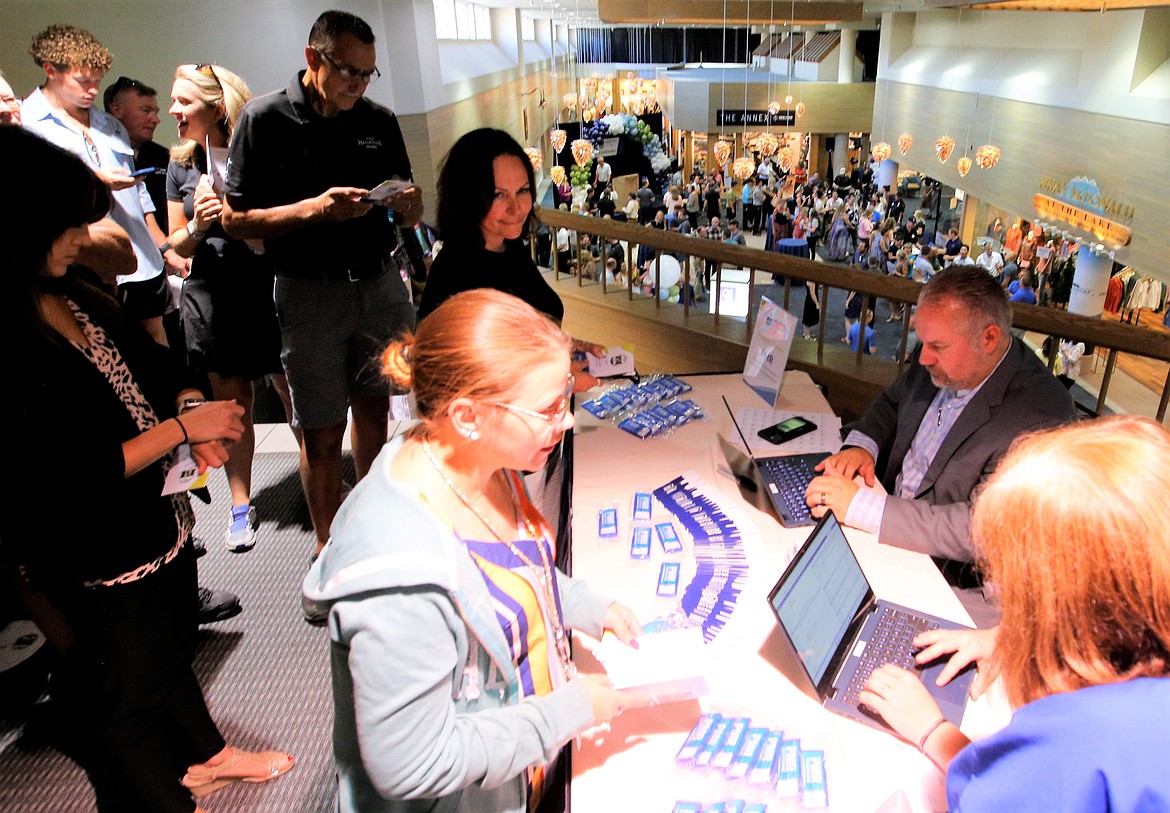 Jared Silvis, PMR healthcare operations manager, focuses on the screen as Hagadone Corp. employees line up during the grand opening of the Hagadone Medical Clinic at The Resort Plaza Shops on Tuesday.