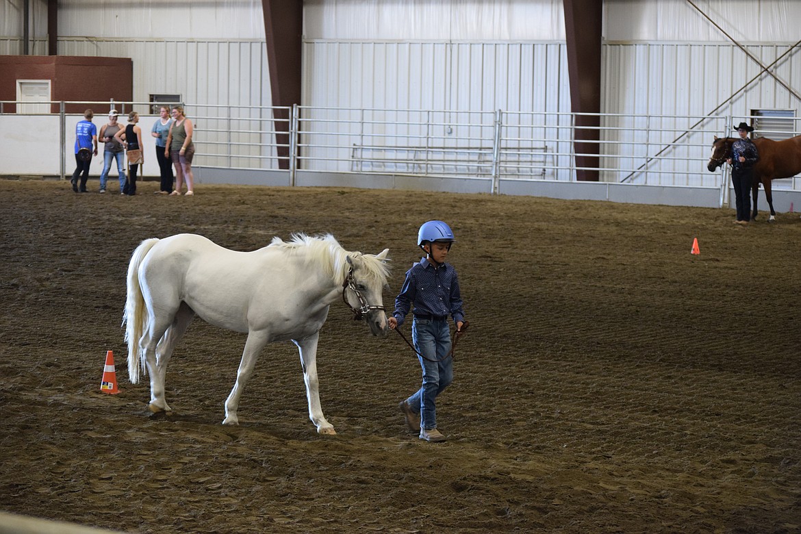 A young rider leads one of the smaller horses along the route to show off his skills. While both the competitor and his animal were smaller than others, they did well and showed that they’d put in work ahead of the competition.