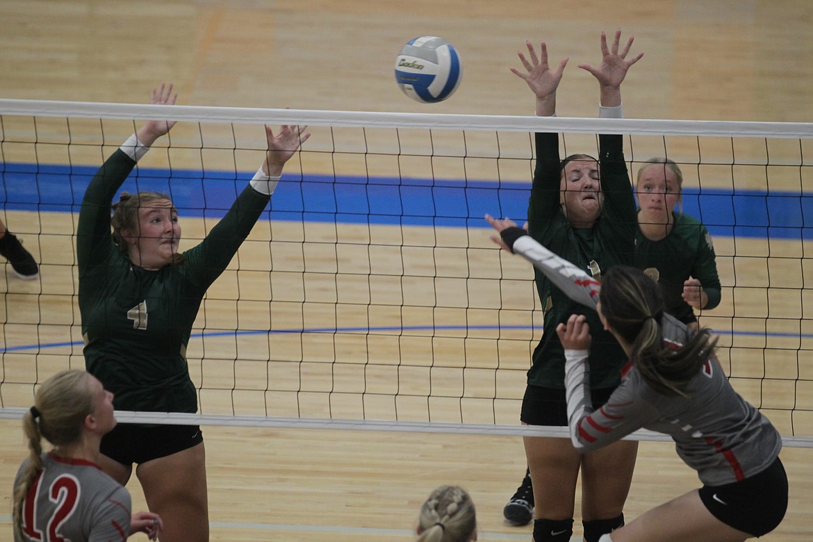 MARK NELKE/Press
Tayla Janssen (4) and Ava Stancil (1) of St. Maries put up a block against Belen Gonzales of Sandpoint on Tuesday at a volleyball jamboree at Coeur d'Alene High.