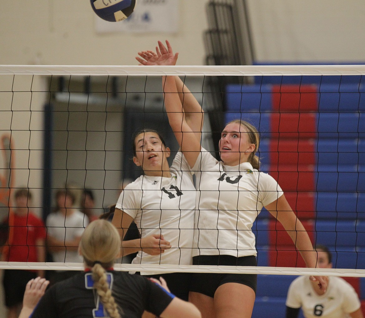 MARK NELKE/Press
Ziya Munyer, left, and Lila Kiefer of Lakeland team to send the ball over the net as Bailey Jaworski of Coeur d'Alene looks on during a volleyball jamboree Tuesday at Coeur d'Alene High.